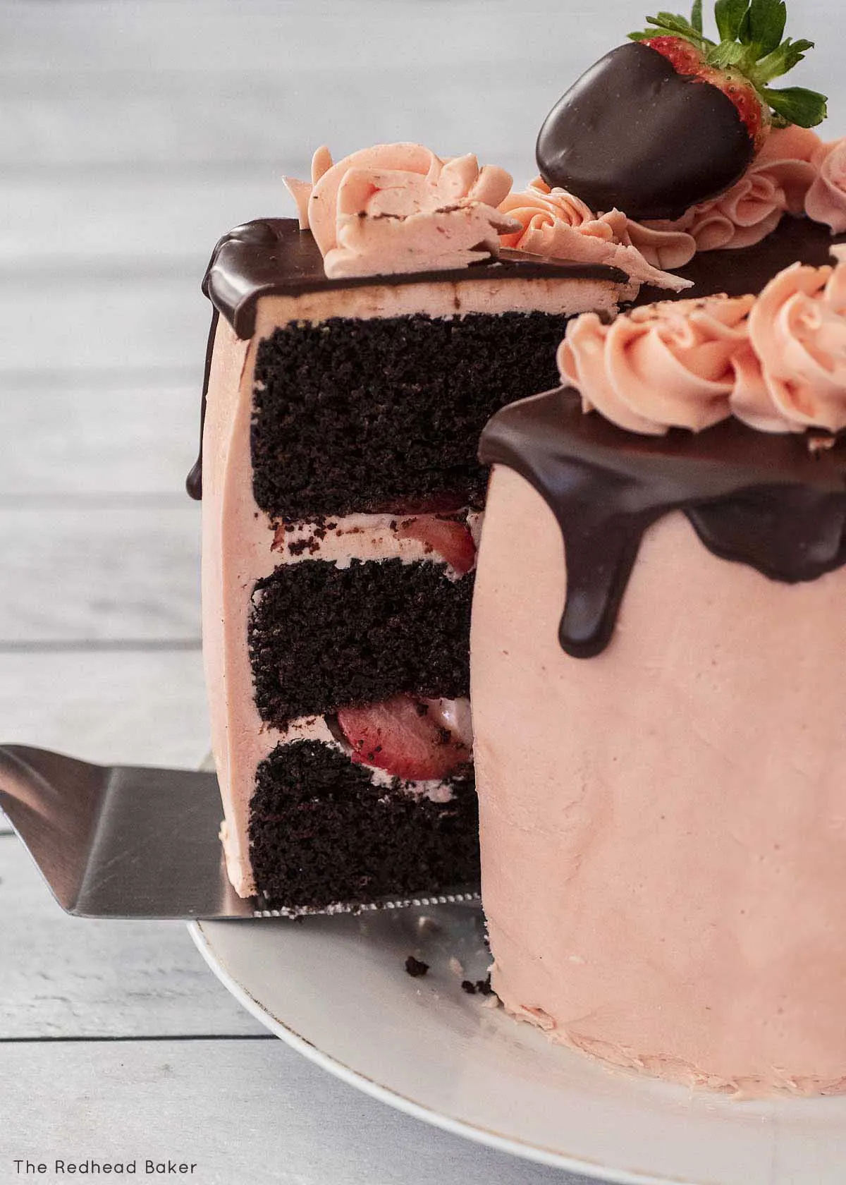 A cake server pulling a slice away from the rest of the cake.