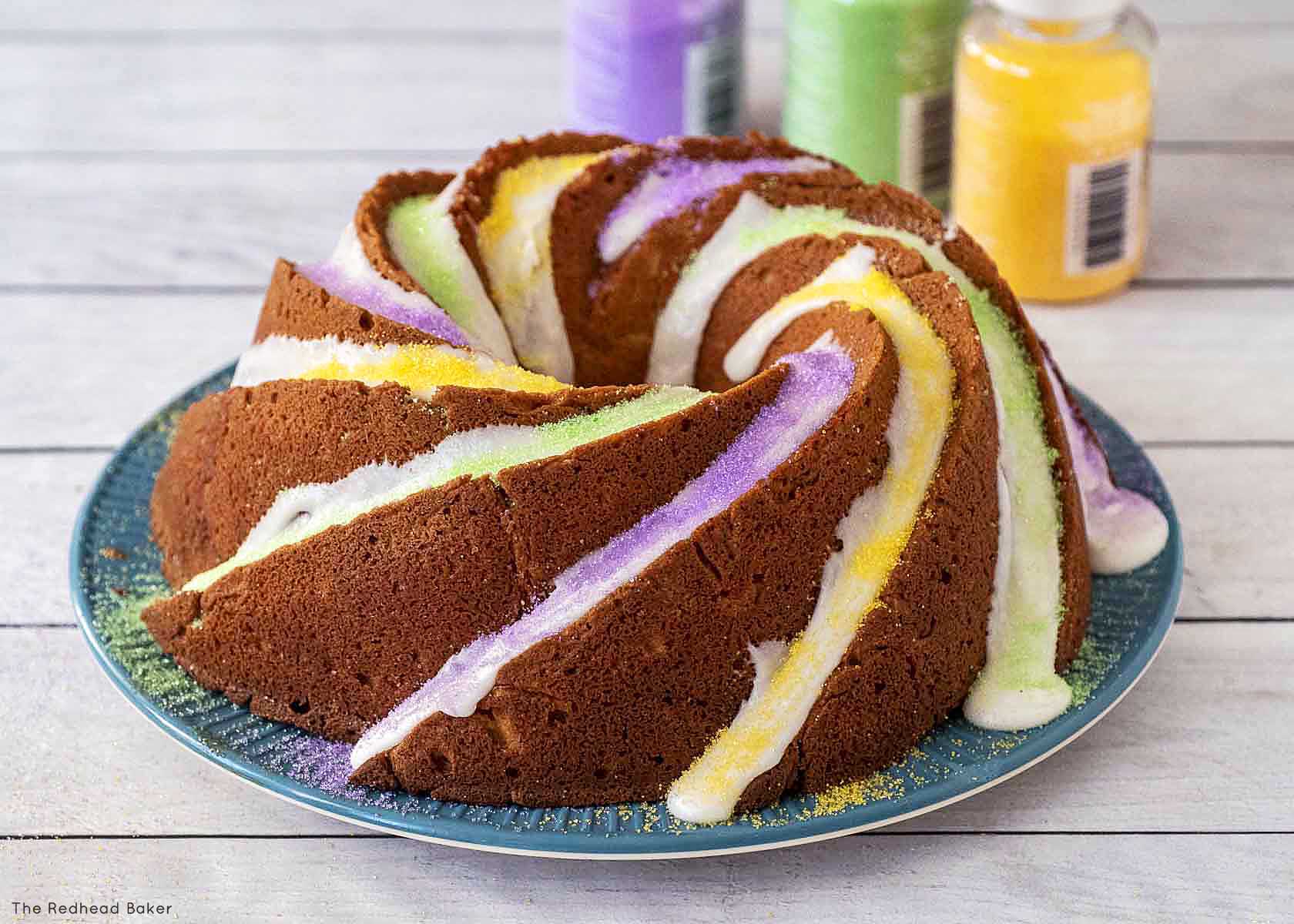 A whole king bundt cake on a blue plate.