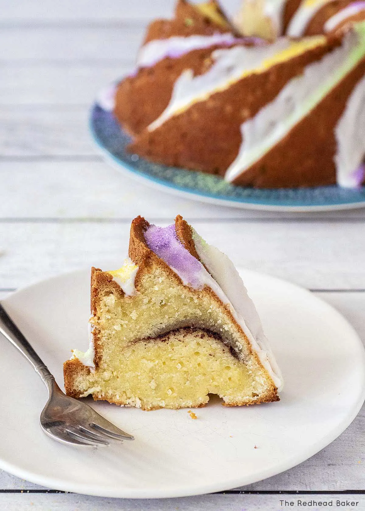 A slice of King Bundt Cake in front of the rest of the cake.