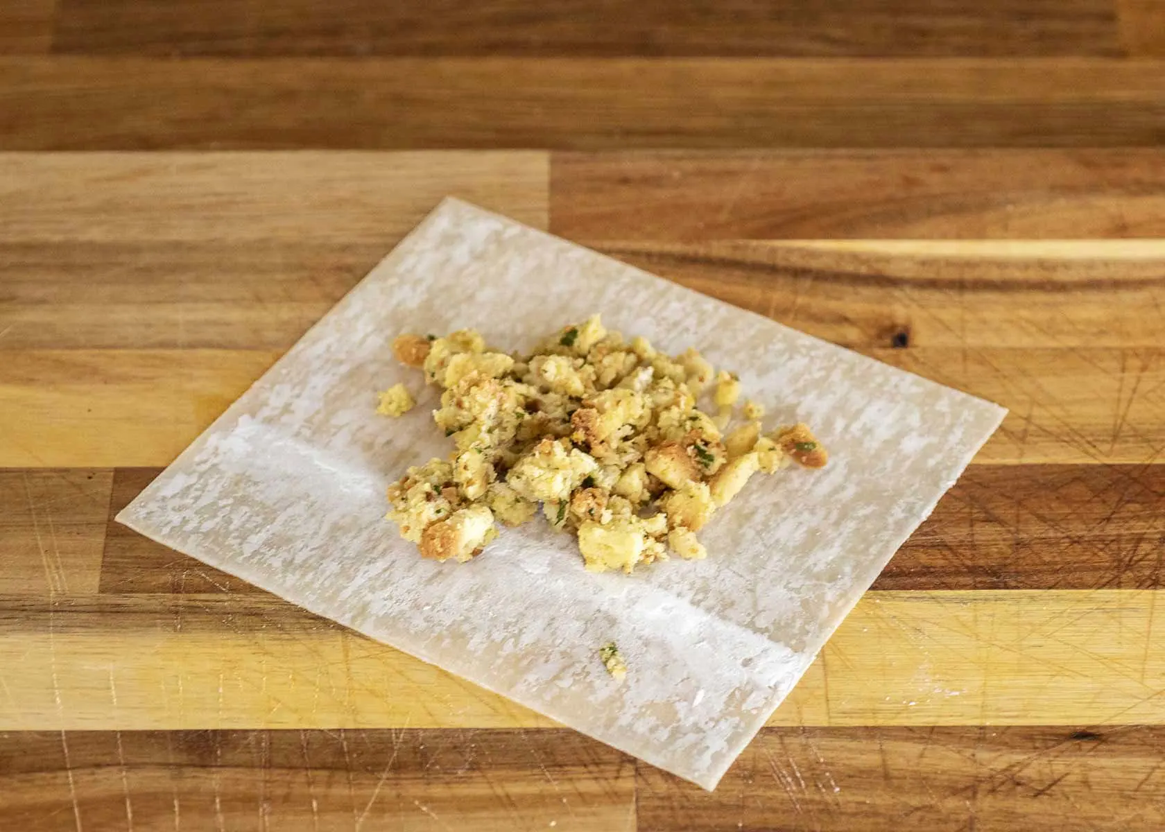Stuffing on a flat egg roll wrapper.