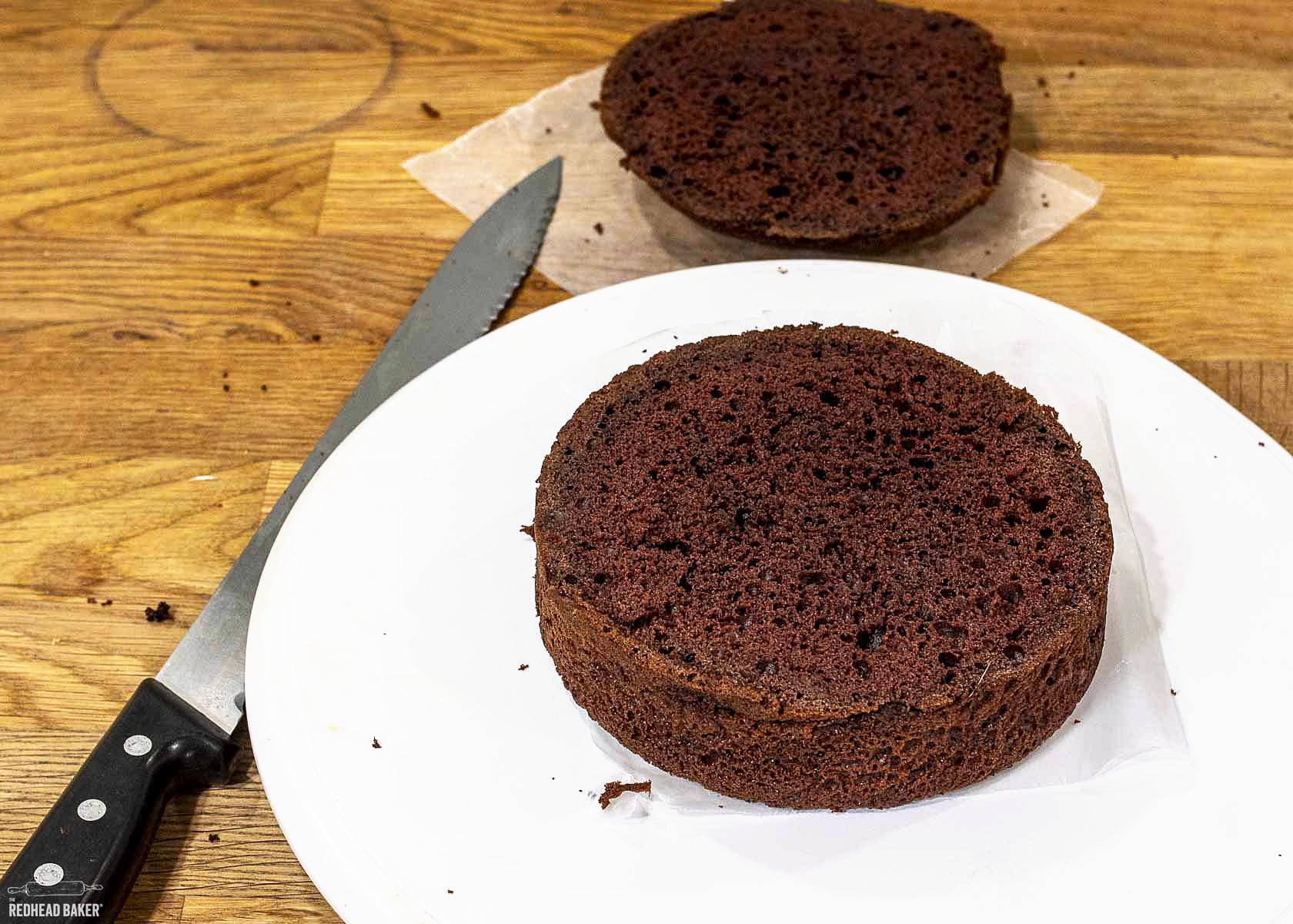 A leveled cake with the removed dome in the background. 