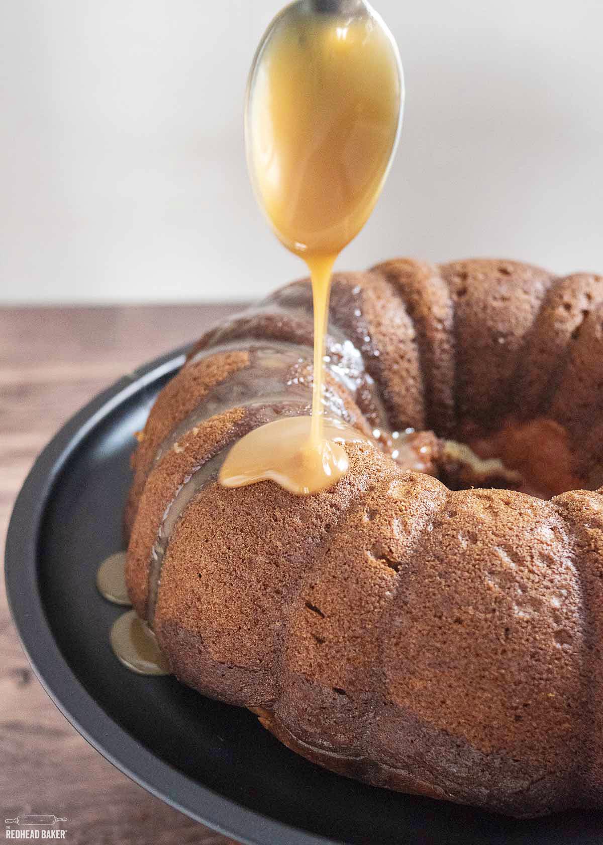 Caramel sauce being drizzled on a bundt cake.