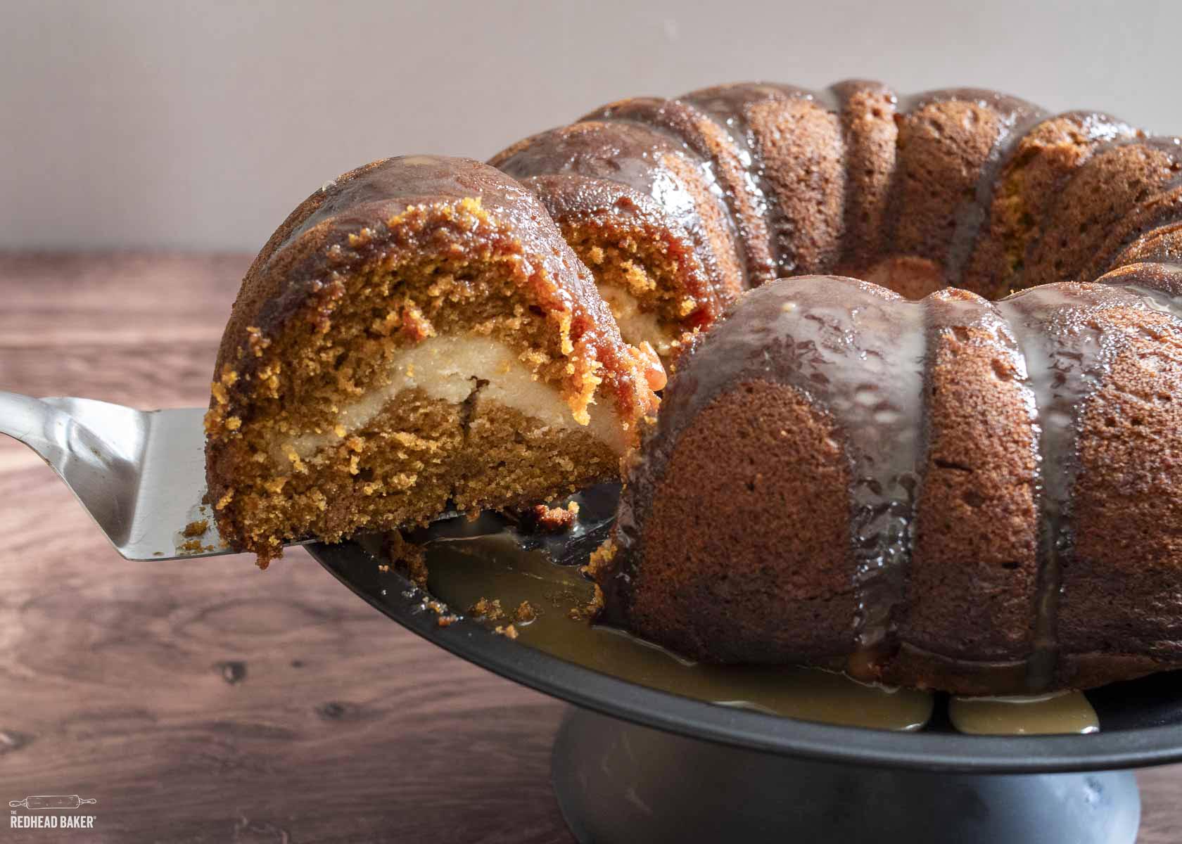 A slice being pulled away from a pumpkin bundt cake.