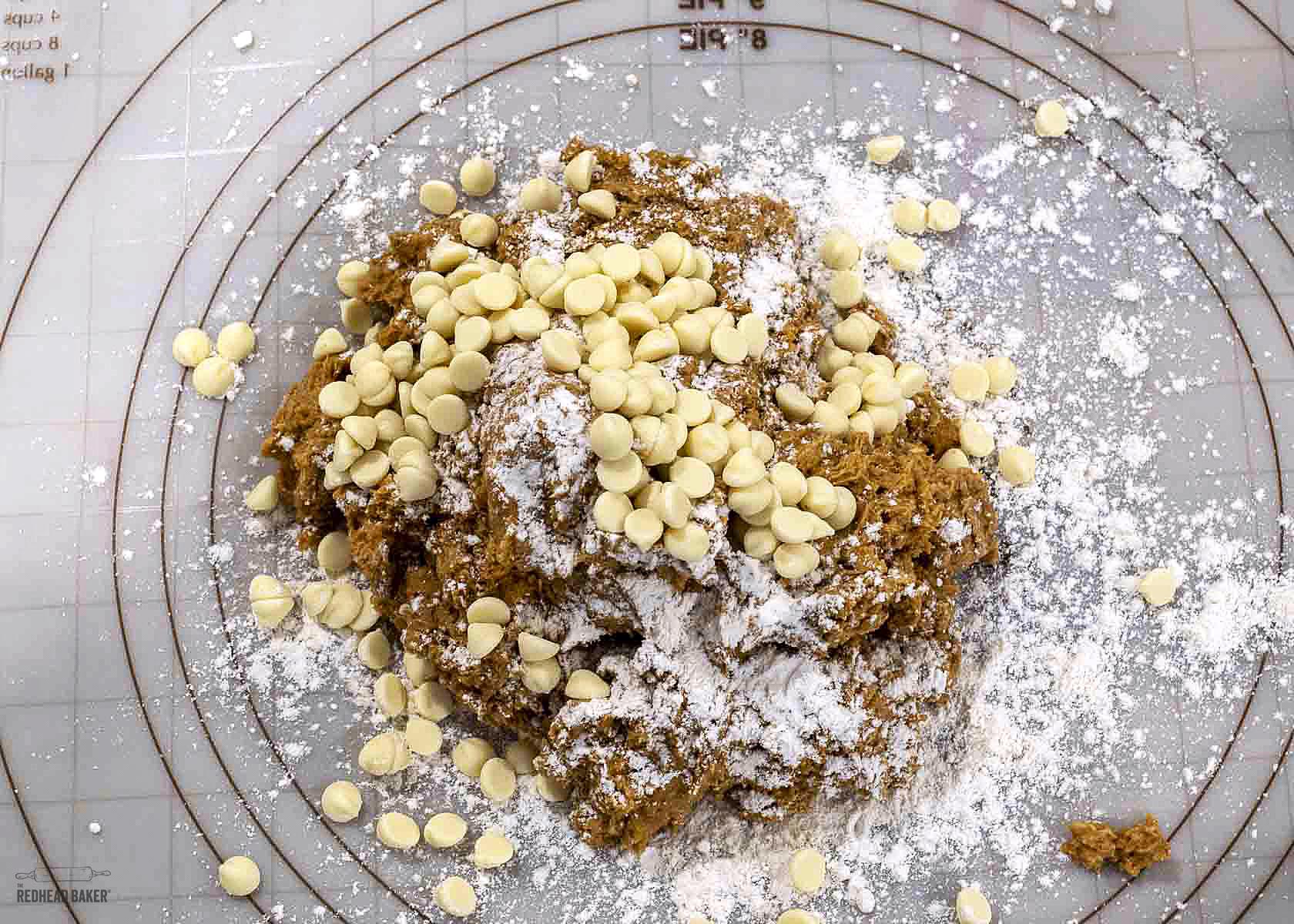 Pumpkin scone dough covered with white chocolate chips. 