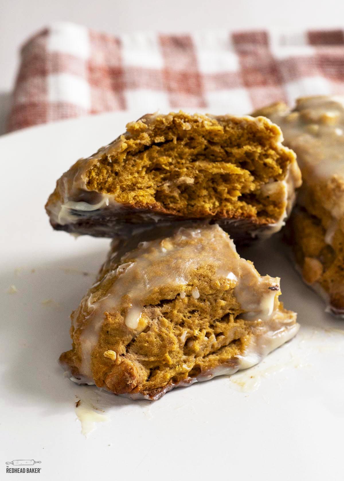 A pumpkin scone broken into two pieces with interior visible. 